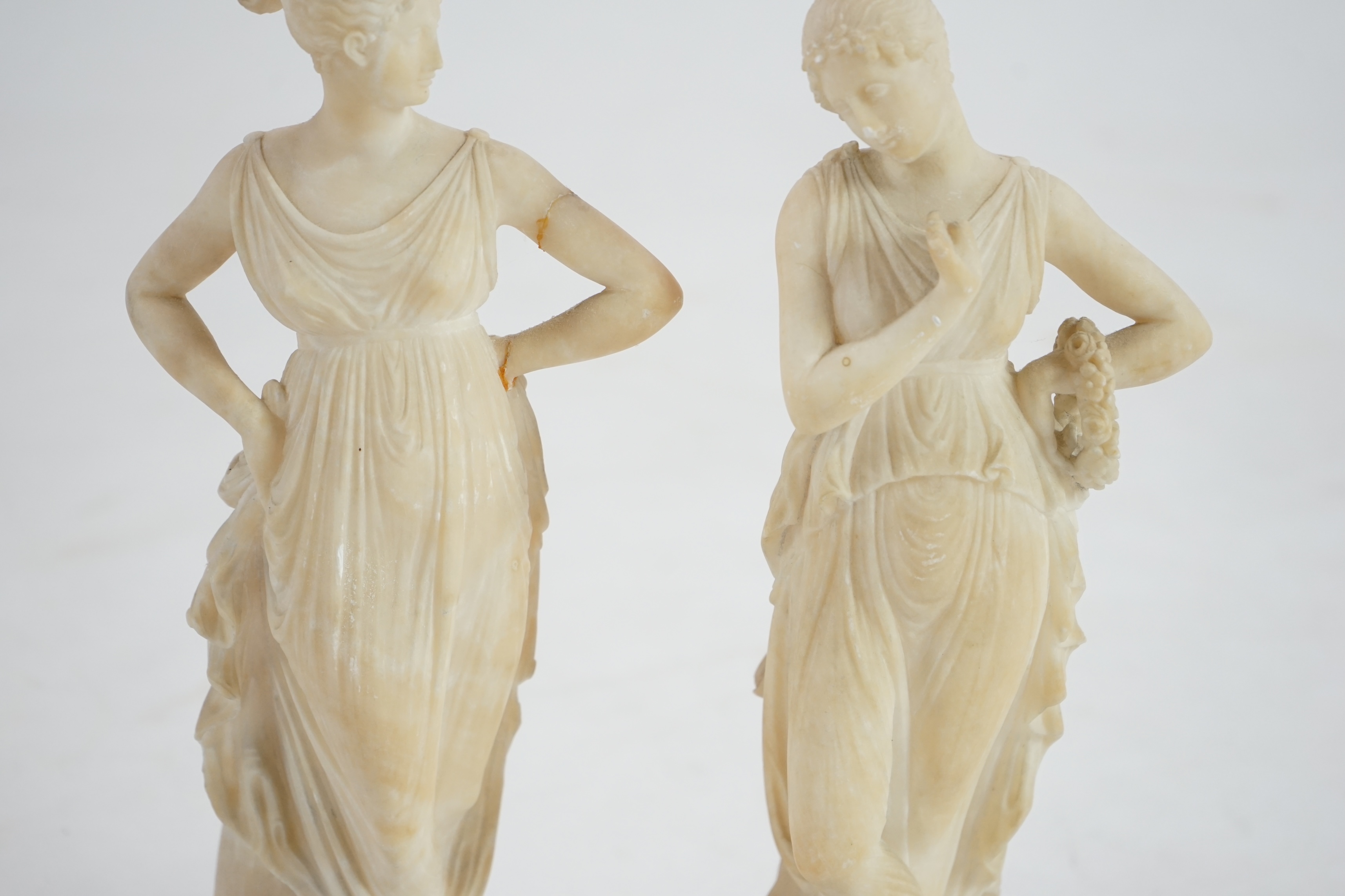 After the antique, a pair of 19th century Italian carved alabaster figures of muses